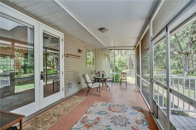 Back porch, screened overlooks fenced back yard and beautiful wooded property beyond | Image 32