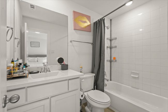 Bathroom featuring shower / tub combo with curtain and vanity | Image 22