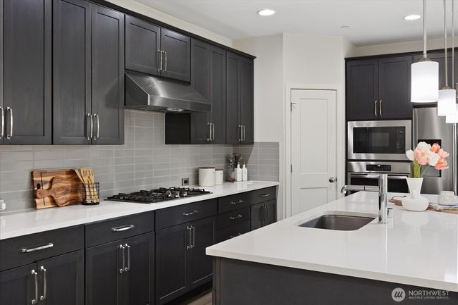 Cook in style with gas stove, tile backsplash and SS appliances | Image 12