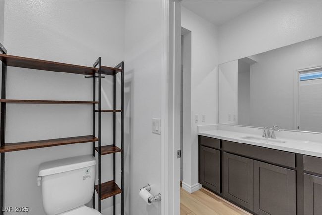 Bathroom with vanity, toilet, wood finished floors, and baseboards | Image 15