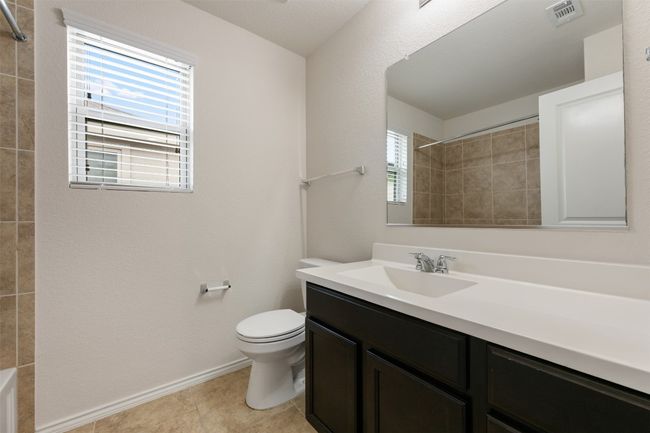 Bathroom featuring toilet, vanity, plenty of natural light, and baseboards | Image 30