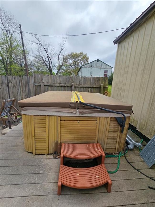 Wooden deck with fence and a hot tub | Image 18