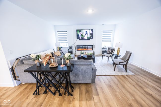 living room featuring light wood-style floors and baseboards | Image 4