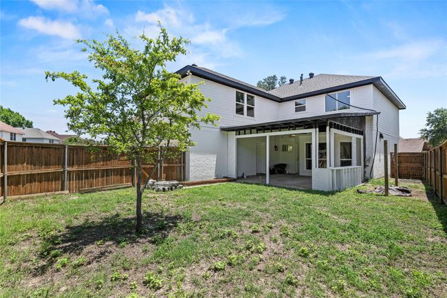 Rear view of house featuring a patio, a fenced backyard, and brick siding | Image 28