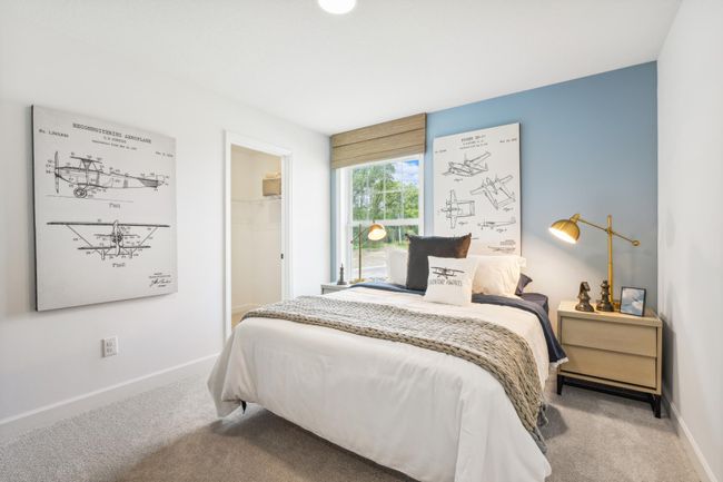 Photo is of the actual model. One of three generously sized upper level secondary bedrooms with spacious closets. | Image 18
