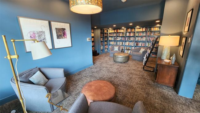 Card room and library adjacent to Lobby with carpet floors and wall of books provide owners and their guests with a welcome retreat. | Image 21