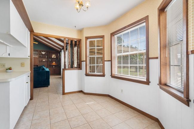 The breakfast are or nook is a perfect place for coffee or a quick bite before school or work. This area opens up to the main living room with the original wooden spindles. | Image 12