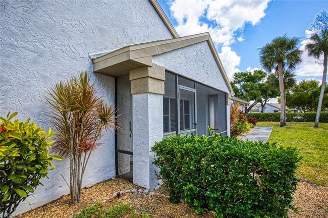 View of side of property featuring stucco siding and a yard | Image 7