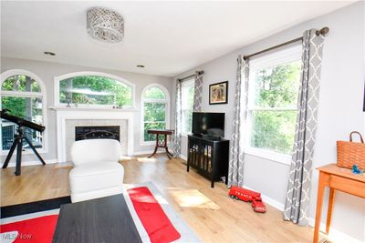 Living room featuring light wood-type flooring and a fireplace | Image 3