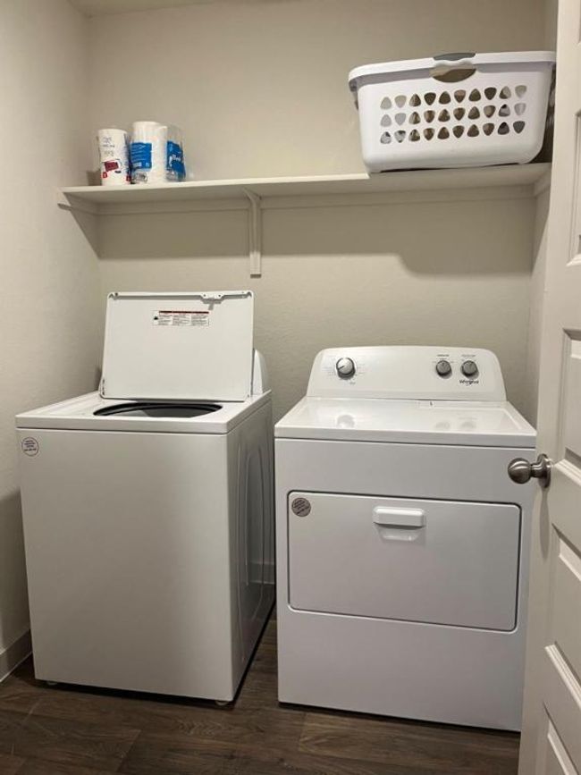 Laundry area with washing machine and clothes dryer and dark wood-style flooring | Image 18