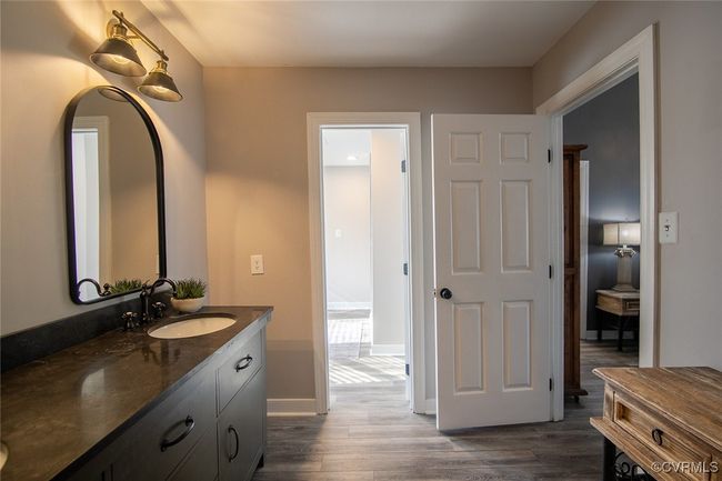 Bathroom with baseboards, wood finished floors, and vanity | Image 35