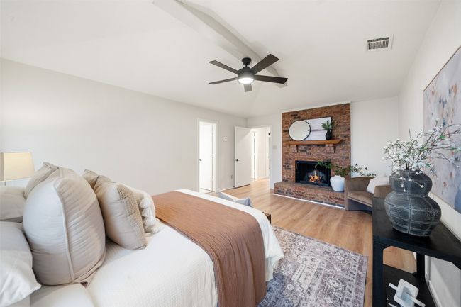 Primary bedroom with fireplace and vaulted ceiling. | Image 12