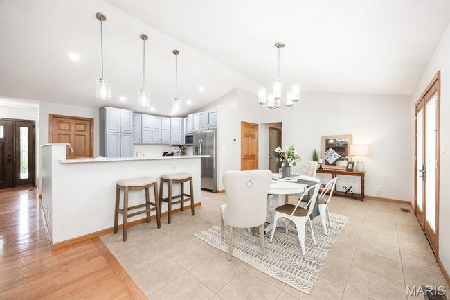 Dining room featuring vaulted ceiling, a chandelier, recessed lighting, and baseboards | Image 14