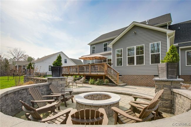 Rear view of property with a fire pit, a wooden deck, and a patio area | Image 40