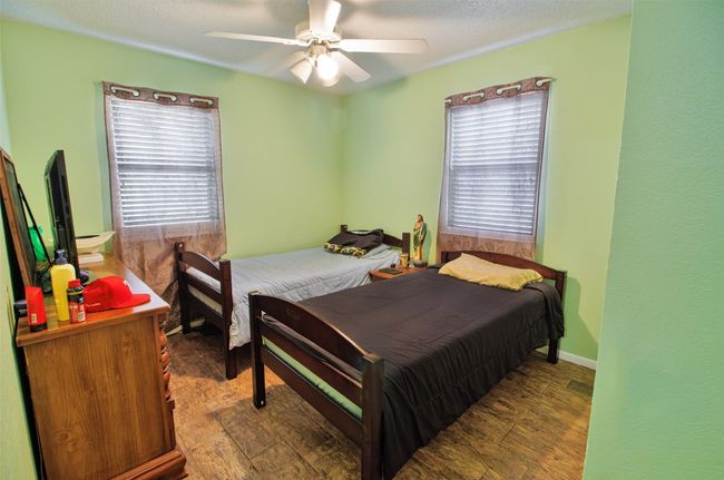 Bedroom featuring a ceiling fan and baseboards | Image 12