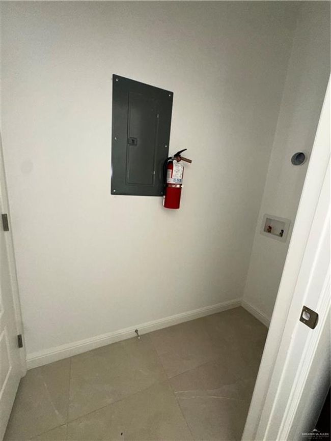 Washroom featuring hookup for a washing machine, baseboards, laundry area, electric panel, and tile patterned floors | Image 11