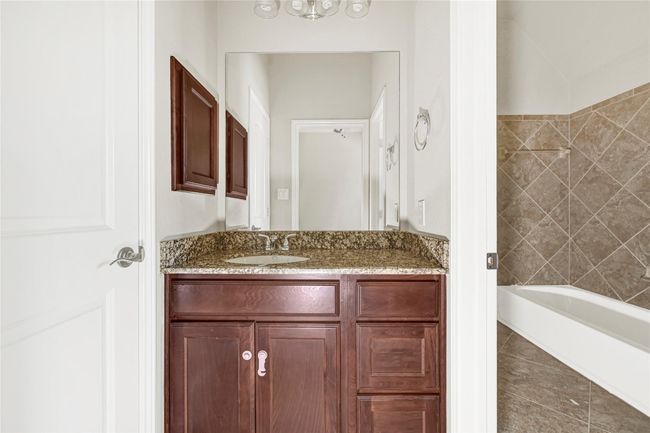 A well-designed Jack-and-Jill bathroom connects two bedrooms, with separate vanity areas at each end—an ideal layout for both privacy and convenience. | Image 36