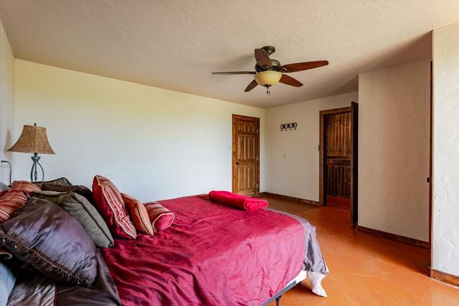 Bedroom with ceiling fan and baseboards | Image 26