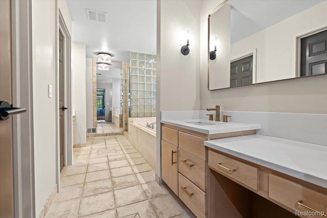 Primary bedroom with dual vanities. | Image 25