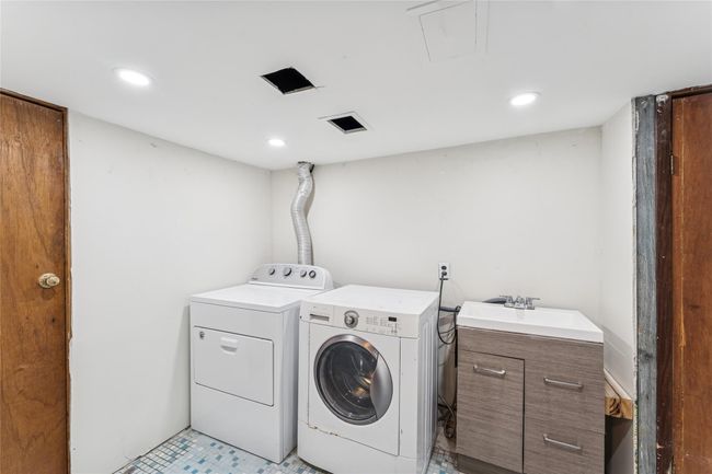 Laundry room featuring visible vents, laundry area, recessed lighting, a sink, and separate washer and dryer | Image 13