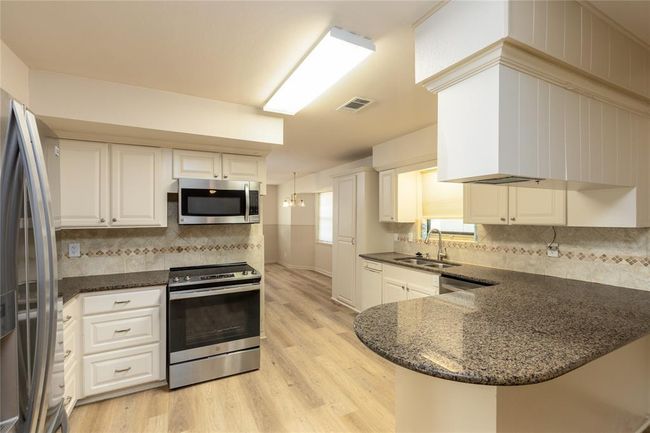 Kitchen has been updated with Granite counter top and Tile back splash | Image 12