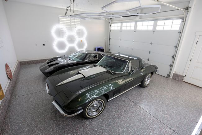 new epoxy floor in main garage with hexagon lights on walls and ceiling. | Image 103