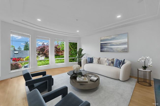 Living room with wood finished floors, recessed lighting, and a raised ceiling | Image 22
