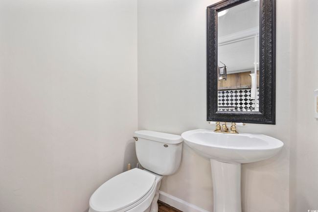 Bathroom with toilet, baseboards, and wood finished floors | Image 34