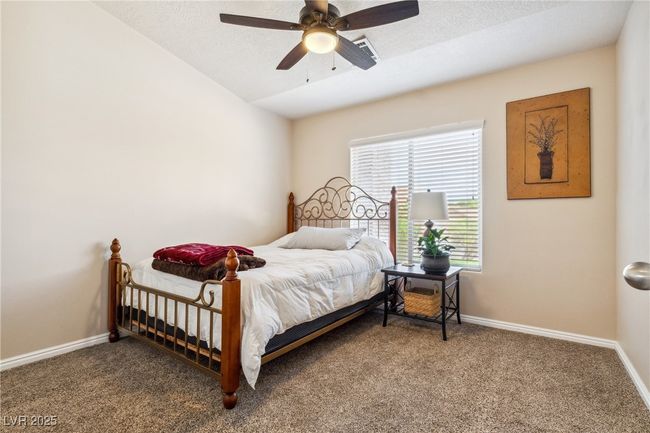 Bedroom with carpet floors, baseboards, ceiling fan, and lofted ceiling | Image 22