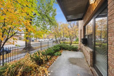 Covered patio, lush landscaping and a beautiful brick exterior, great for grilling and relaxing | Image 2