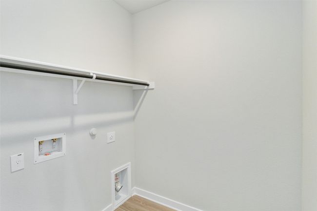 Clothes washing area featuring washer hookup, gas dryer hookup, electric dryer hookup, light wood-type flooring, and laundry area | Image 27