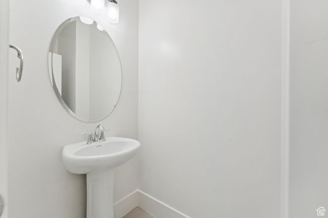 Bathroom featuring baseboards and a sink | Image 12