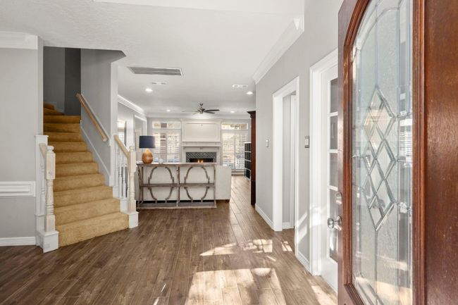 Foyer welcomes guests with neutral paint, white ceilings, crown moldings, a home office to the right and dining room to the left, as you enter. | Image 7