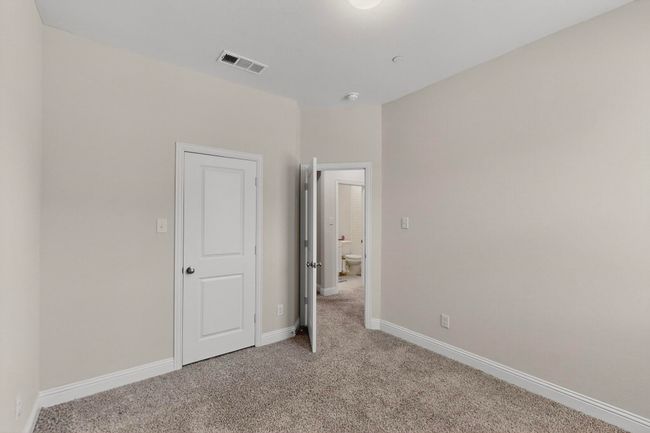 Unfurnished bedroom featuring light colored carpet and baseboards | Image 29