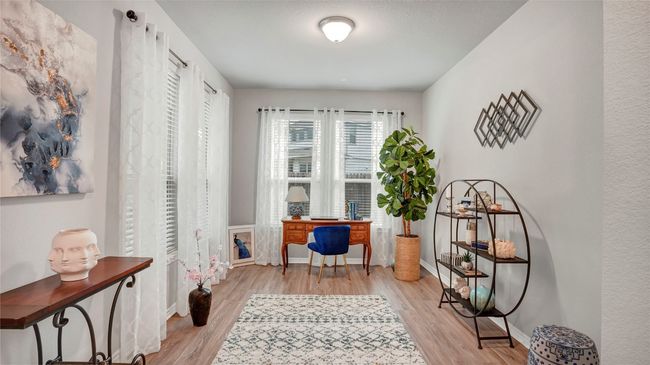 Home office with baseboards and light wood finished floors | Image 17