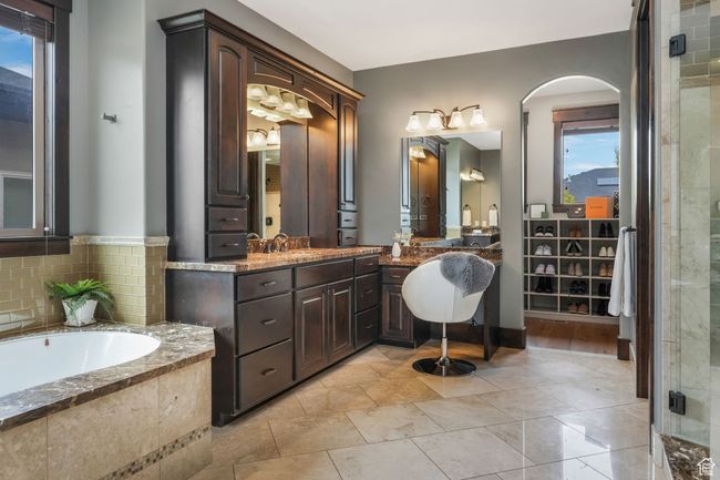 Primary Bathroom featuring a bath, a wealth of natural light, vanity, and a jetted, heated, aerated tub. | Image 7