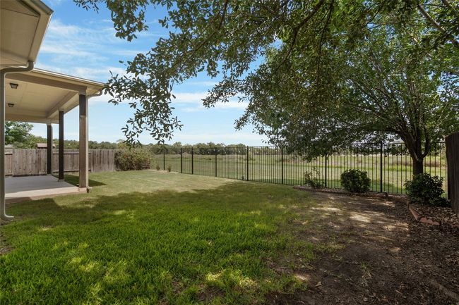 Fenced backyard with a patio | Image 40