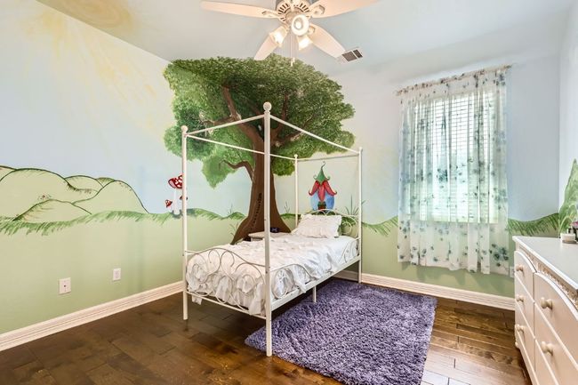 Upstairs bedroom with hardwood floor and ceiling fan | Image 19