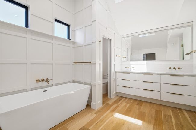 Primary bathroom with custom board and batten throughout | Image 14