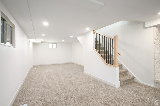 Basement with recessed lighting, carpet, stairs, and baseboards | Image 12