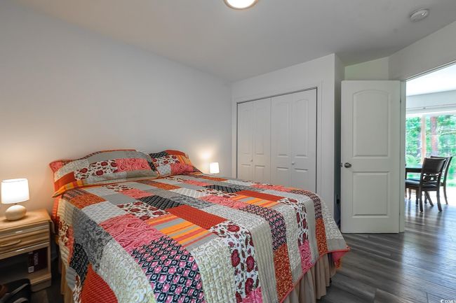 Bedroom featuring dark wood finished floors and a closet | Image 9