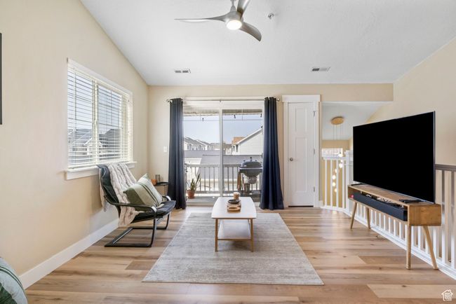 Living room featuring light wood-style flooring, ceiling fan, baseboards, and visible vents | Image 7