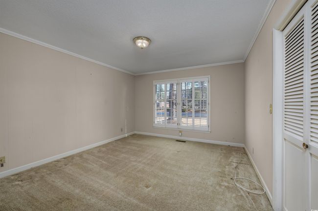 Unfurnished bedroom featuring light carpet and ornamental molding | Image 25