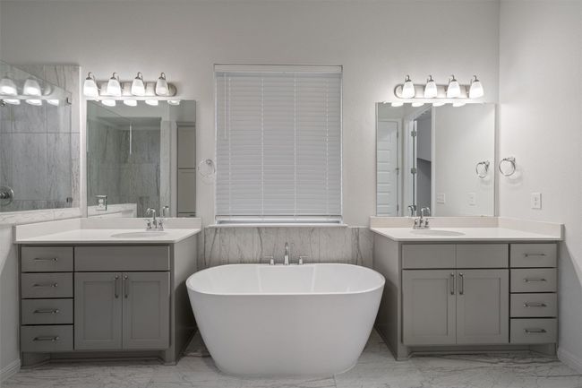 Full bathroom featuring marble finish floor, a soaking tub, and a sink | Image 17