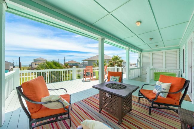 A cool and colorful spot to chill and you can peek the water view. A Firepit table not pictured here is NEW! Beyond this seating area you can see the covered stairs and a LIFT! | Image 37