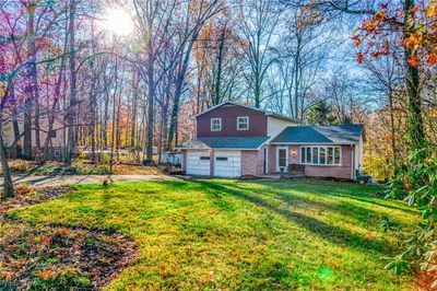 View of front of property with a front yard and a garage | Image 2