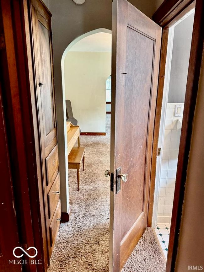 corridor featuring arched walkways and carpet flooring | Image 28