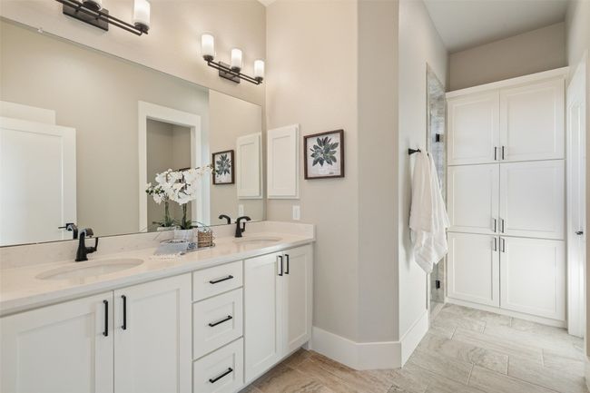 Full bathroom with double vanity and baseboards | Image 14