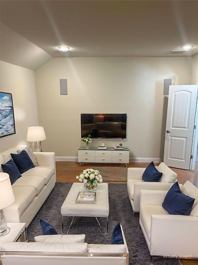Living room with vaulted ceiling and wood finished floors | Image 19