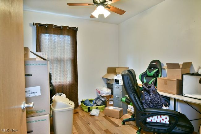 Office area featuring a ceiling fan and wood finished floors | Image 19